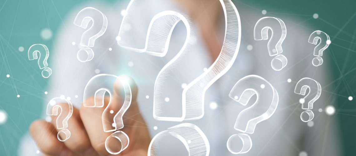 Businesswoman on blurred background touching and holding hand drawn question marks