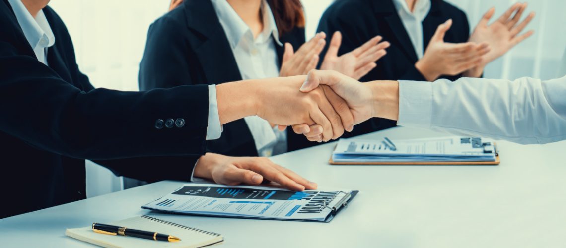 Business people group handshake at meeting table. Job interview success or making successful business oratory agreement
